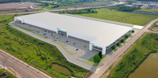 Magna facility in Brampton. White building surrounded by greenery.