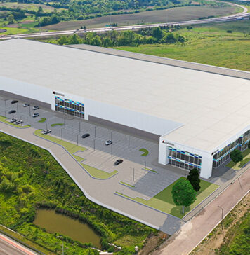 Magna facility in Brampton. White building surrounded by greenery.